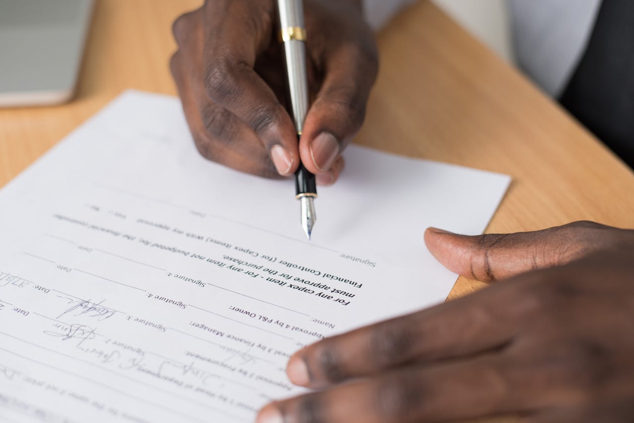 man signing a document